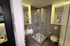 Shower, hair dryer, towels, toilet paper