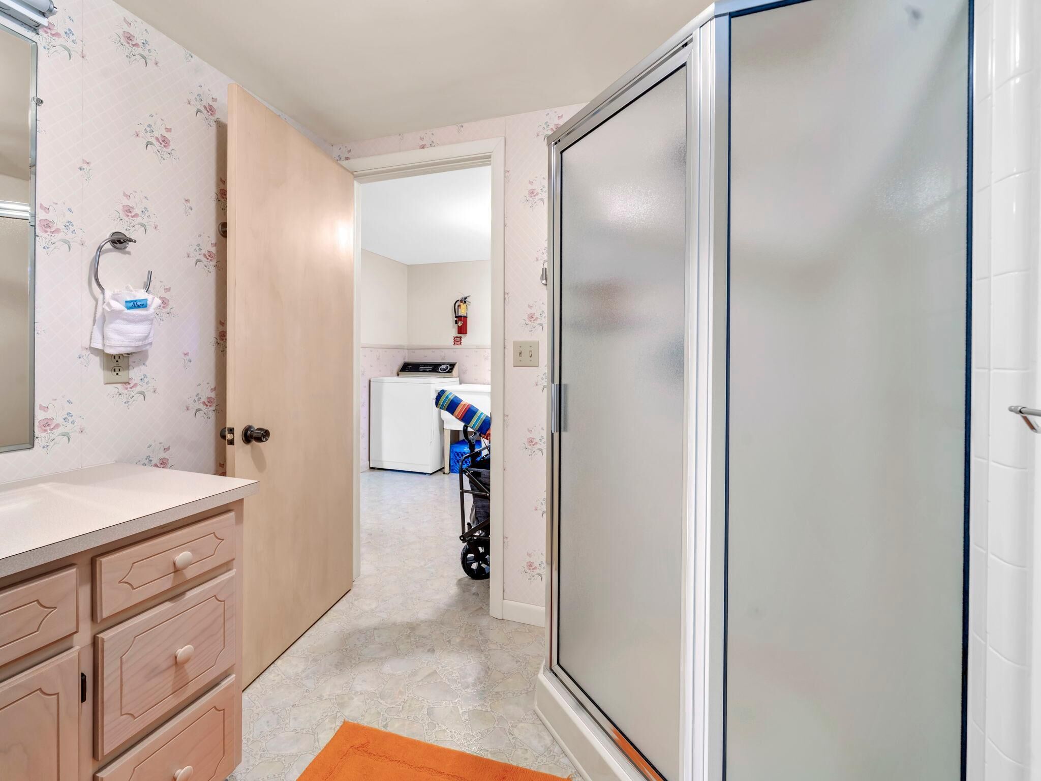 A bathroom with a shower, a toilet, and a sink.