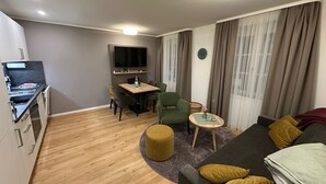 A compact living space with a kitchenette, dining area, and seating area. - Apartment Ahrblick (1-4 persons) | Top vacation apartment with a view of the Ahr (Altenahr)