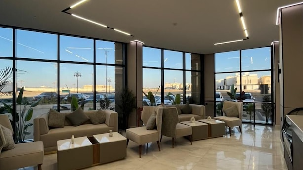 A spacious lobby with large windows, a modern sofa area, and a clean, tiled floor. - Aswar Plus for serviced apartments (Tabuk)