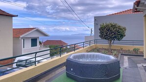 A rooftop with a hot tub, a small tree, and a view of the sea. - Gaula Family Haven by Atlantic Holiday (Gaula)