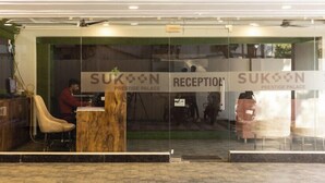 A reception area with a sign reading "SUKON RECEPTION" and "PRESTIGE PALACE". - Sukoon Prestige Palace (Bhopal)