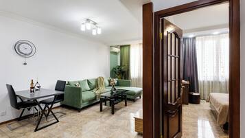 Standard Apartment, City View | Living area | 50-inch flat-screen TV with cable channels