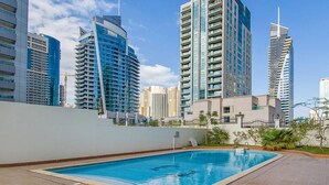 A rooftop swimming pool with a view of modern high-rise buildings. - Diamond 6 Residences by CEG Group (Dubai)