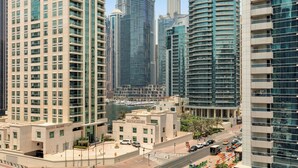 A modern high-rise hotel with a marina view, featuring a prominent tower and multiple balconies. - Diamond 6 Residences by CEG Group (Dubai)