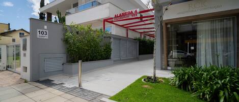A modern building with a sign reading "Alameda 4 residence 103".