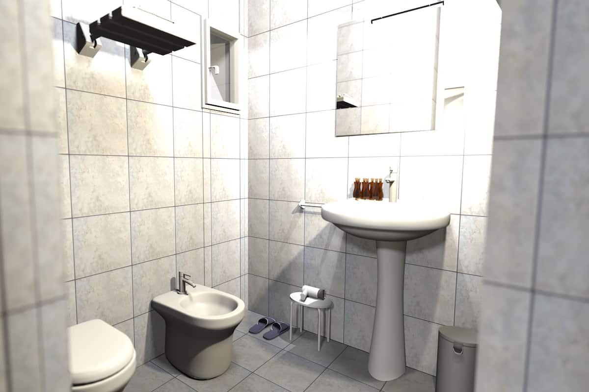 Une salle de bain moderne équipée de toilettes, d’un bidet, d’un lavabo et d’un miroir.