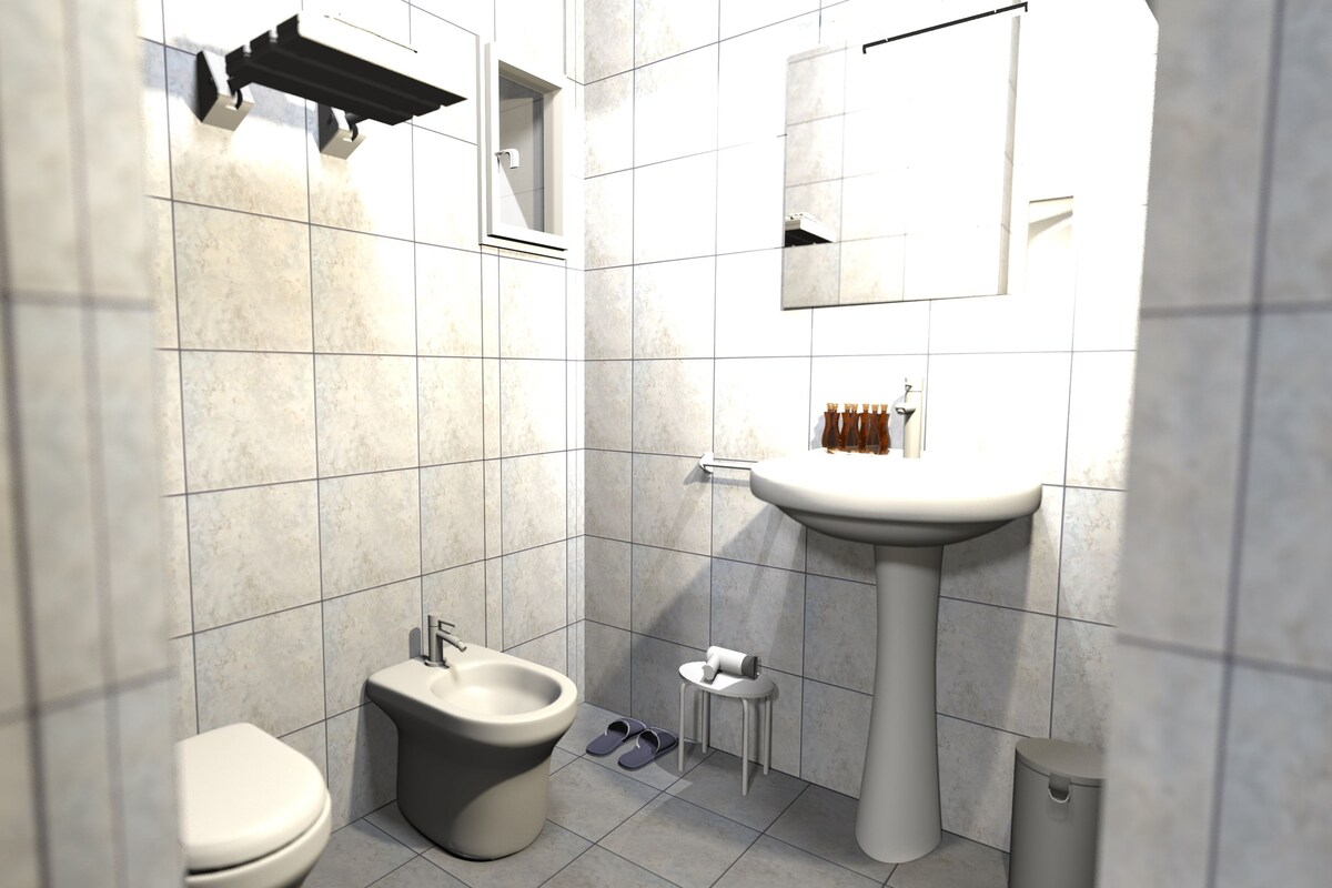 Un baño moderno con inodoro, bidé, lavamanos y espejo.