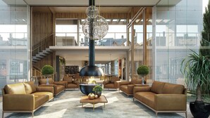 A spacious living area with leather sofas, a central coffee table, and a unique chandelier. - Veneto Residential / 2 Suites / 8 PAX / By HOUSINGCEARA (Gramado)