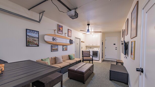 A compact living space with a sofa, ottoman, and a dining table. - Walk to beach, 3/2 w/Views, Deck & Accessibility (Cayucos)