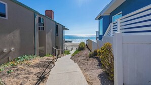 A pathway leading to a beach with a clear view of the ocean. - Walk to beach, 3/2 w/Views, Deck & Accessibility (Cayucos)
