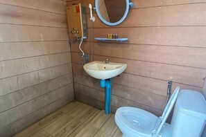 A small bathroom with a sink, toilet, and mirror. - Mon View Ngam (Mae Rim)