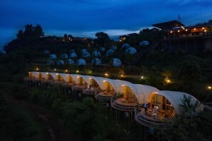 A series of dome-shaped tents with outdoor seating areas, surrounded by lush greenery. - Mon View Ngam (Mae Rim)