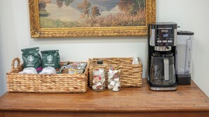 A coffee maker, Starbucks bags, and jars on a wooden table. - Downtown Luxury Apartment I Full Kitchen I W/D (Moscow)