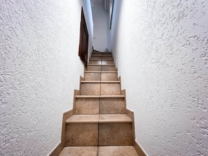 A staircase with a handrail and a landing at the top.