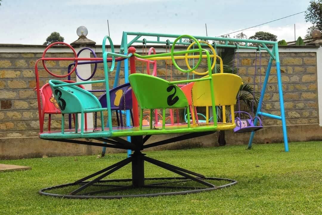 A playground with a seesaw and swings.