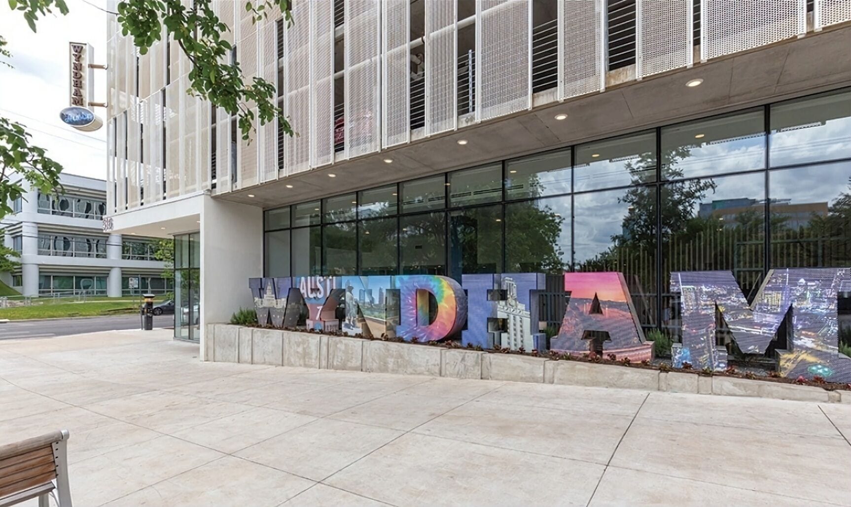 A modern building with large glass windows and a sign that reads "WYNDEHAM".