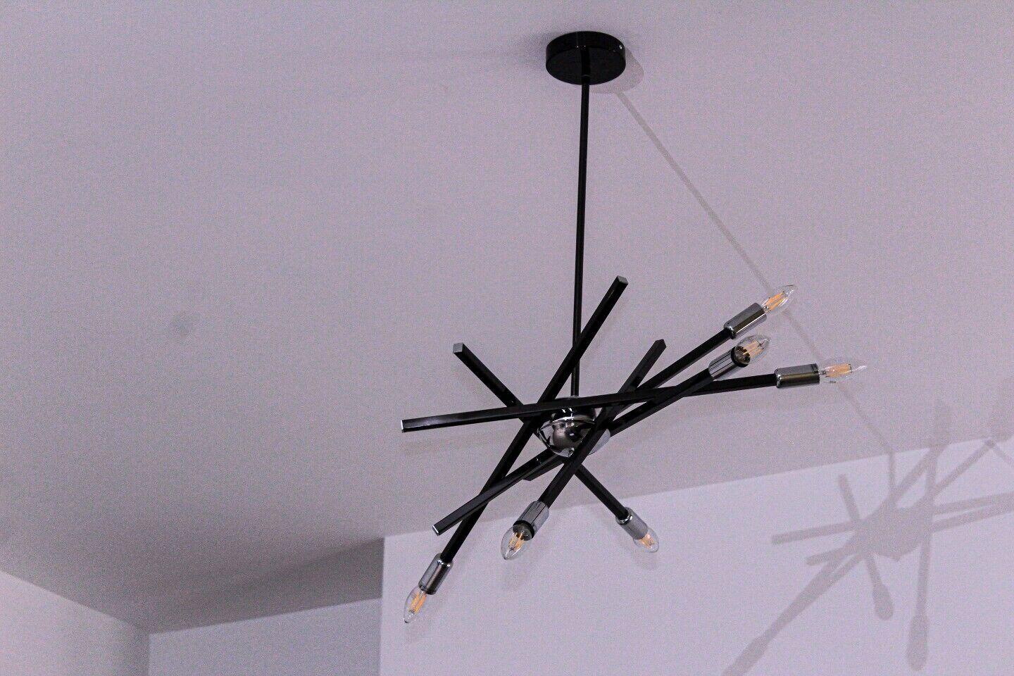 A modern chandelier with multiple arms and bulbs.