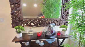 A wooden vanity with a large mirror, a small potted plant, and a coffee maker on the counter. - Beautiful LOFT SUITE, Private Guest House located in Hamlet of Mirror. (Mirror)
