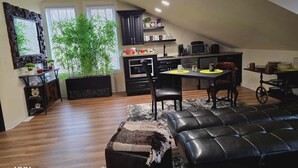 A compact living space with a dining area, kitchenette, and seating area. - Beautiful LOFT SUITE, Private Guest House located in Hamlet of Mirror. (Mirror)