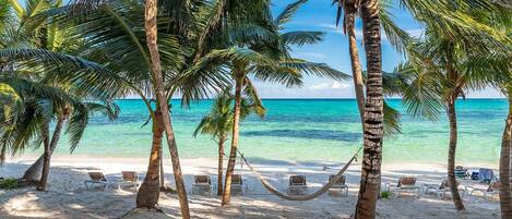On the beach, sun loungers, beach towels