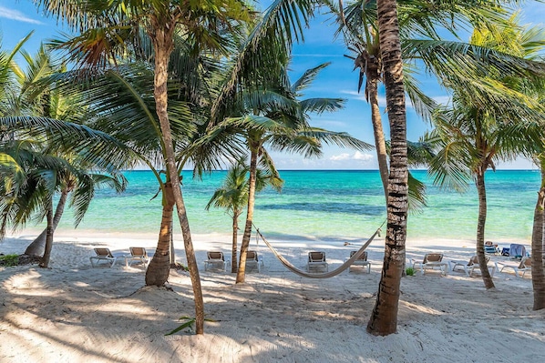On the beach, sun loungers, beach towels
