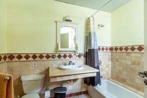 A bathroom with a toilet, sink, and bathtub. - "galeria Beach", Ocean Front! (Sosúa)