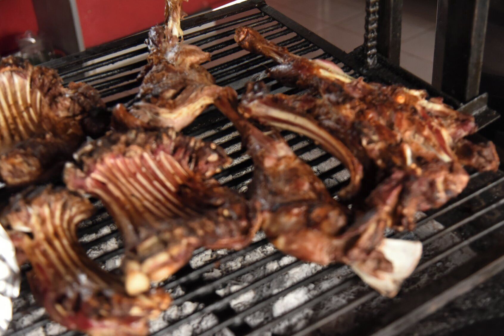 A grill with various meats being cooked.