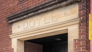 A building entrance with a nameplate reading 'DOYLE.' - Hotel Quality/ Walkable / Free Parking/ Office #7 (Lakewood)
