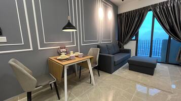 Family Studio Suite, Balcony, City View | Living area | Offices
