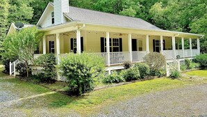 A single-story house with a porch, a chimney, and a satellite dish. - Etowah Valley Ranch - Peaceful, private, and serene!  CLose to everything! (Dahlonega)
