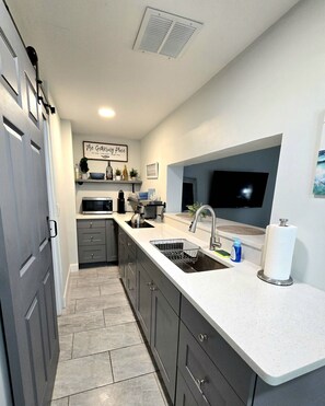 Fridge, stovetop, coffee/tea maker, cookware/dishes/utensils