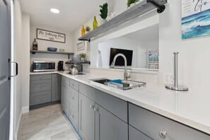 Fridge, microwave, cookware/dishes/utensils, dining tables