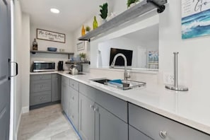 Fridge, microwave, cookware/dishes/utensils, dining tables