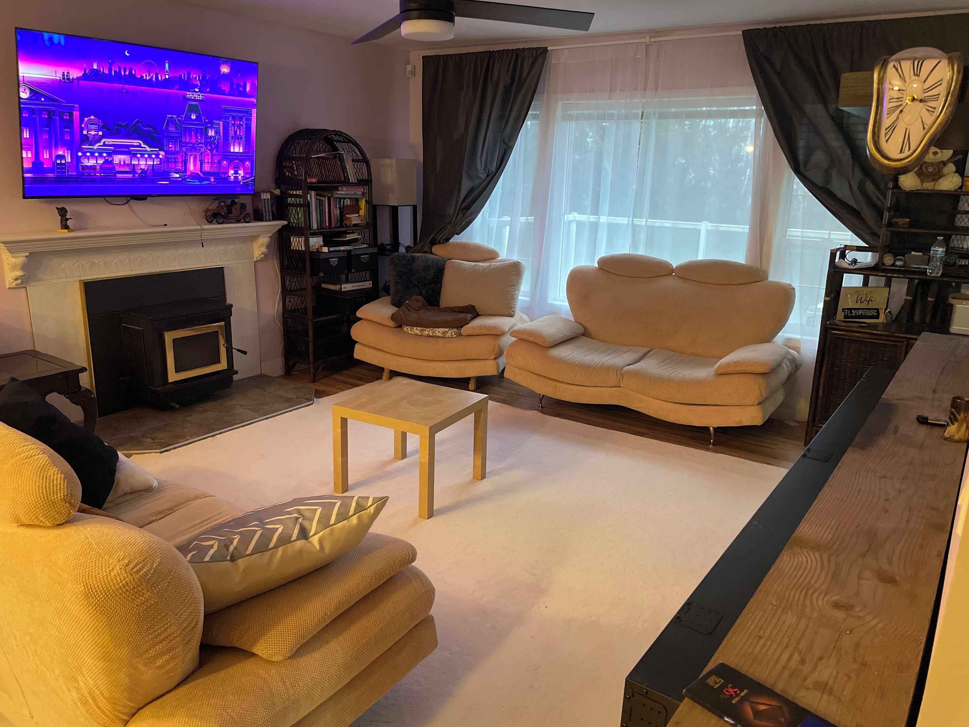 A living room with a fireplace, a television, a sofa, and a coffee table.