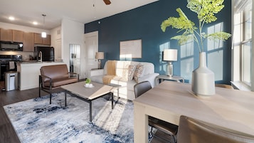 A modern apartment with a kitchen, living room, and dining area.