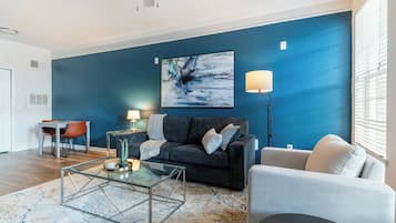 Apartment, 1 Bedroom | Living area | 50-inch TV with digital channels