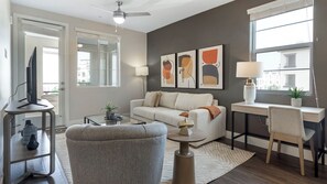 Apartment, 1 Bedroom | Living area | 50-inch TV with digital channels