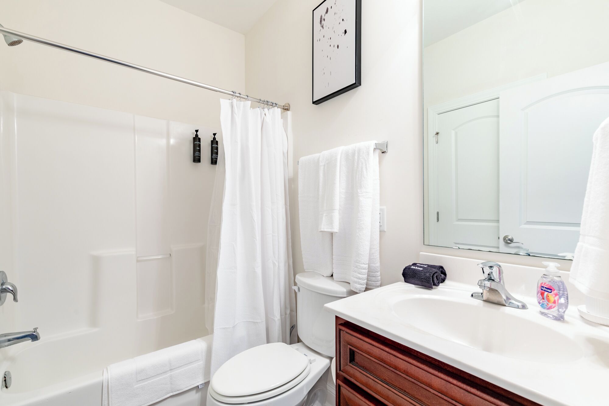 A bathroom with a bathtub, toilet, and sink.