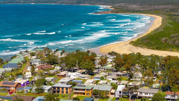 Una zona residencial costera con casas y una playa.
