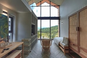 A room with a large window, a bed, a wooden chair, a desk, and a wardrobe. - Talula Hill Farmstay Kluang (Kluang)
