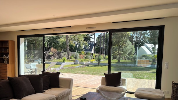 A modern living room with a large glass door leading to a garden. - ARCHITECT HOUSE SOUTH FACING 2 min FROM THE LANSERIA BEACH QUIMIAC MESQUER (Mesquer)