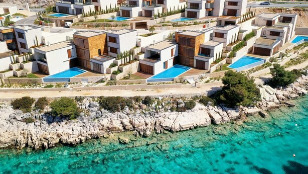 A coastal resort with modern villas, swimming pools, and rocky terrain. - Villa Flora Mare IV with Two Pools (Primošten)