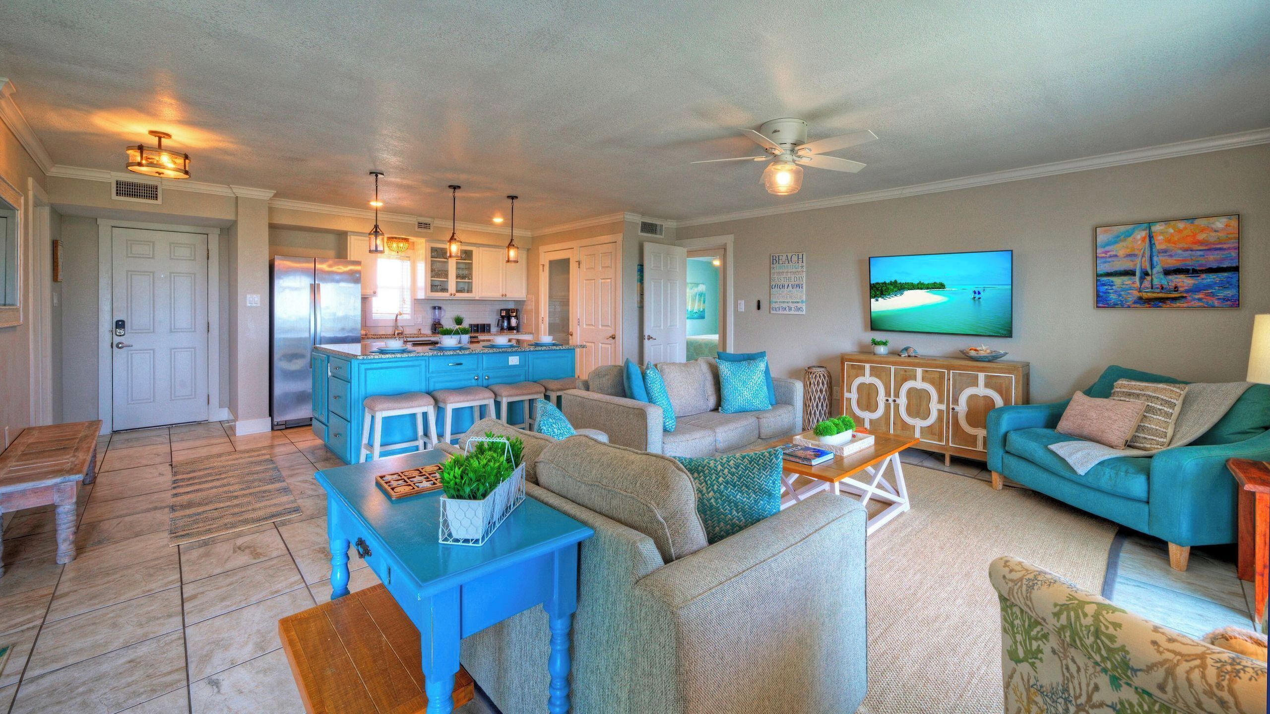 A spacious living area with a kitchen, a dining table, and a sofa.
