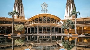 Ένα σύγχρονο ξενοδοχείο με έναν κεντρικό αίθριο, μια πισίνα και δύο ψηλούς πύργους.