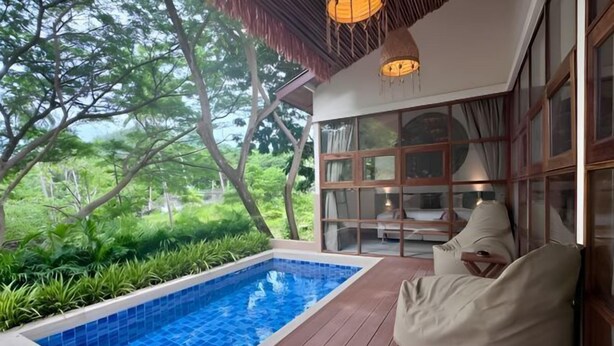 A poolside area with a view of lush greenery, a wooden deck, and a seating area with cushions. - Villa Blue Paradise, Villa 22 (Koh Samui)