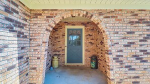 A brick exterior with a door and two trash cans. - Rural Retreat: ‘Cypress Lake’ By Roosevelt St Park (Morton)