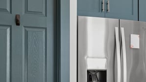 A stainless steel refrigerator with a water dispenser, a teal door, and matching teal cabinets. - NEW, Designer Home Sleeps 10, King Beds, Deck + Blackstone Grill (Indianapolis)