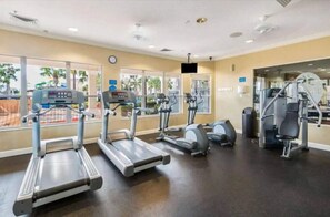 A gym with treadmills, elliptical machines, and weight equipment.