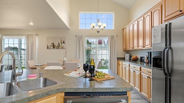 A modern kitchen with granite countertops, stainless steel appliances, and wooden cabinets.